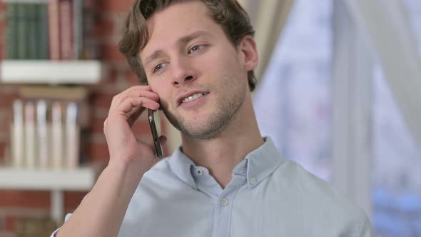 Portrait of Young Man Talking on Smartphone