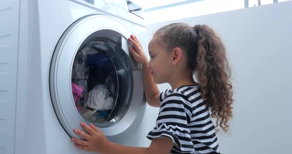 Cute Child Looks Inside the Washing Machine