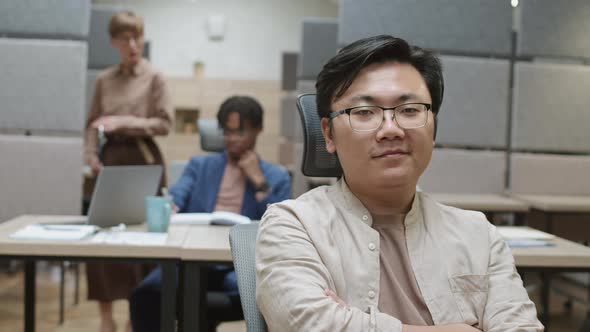 Portrait of Young Asian Man in Office