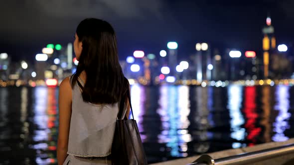 Woman visiting Hong Kong at night 