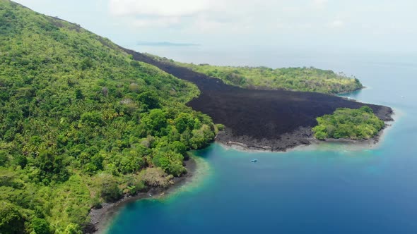 Aerial: flying over Banda Islands active volcano Gunung Api lava flows Indonesia