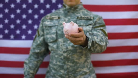 American Serviceman Putting Dollars in Piggy Bank, Social Benefits, Payment