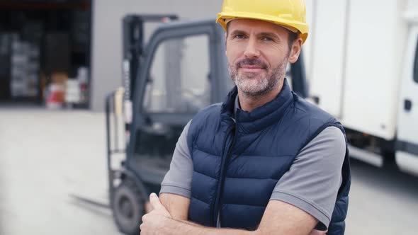 Portrait of caucasian mature man in front of warehouse. Shot with RED helium camera in 8K.