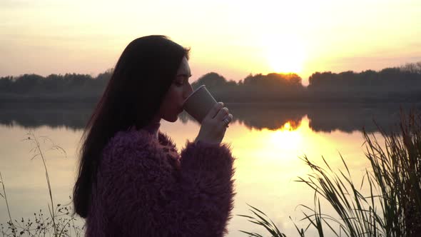 Girl Drinking Coffee At Sunset