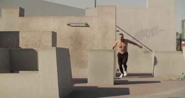 Male Athlete Leaping Over Barrier