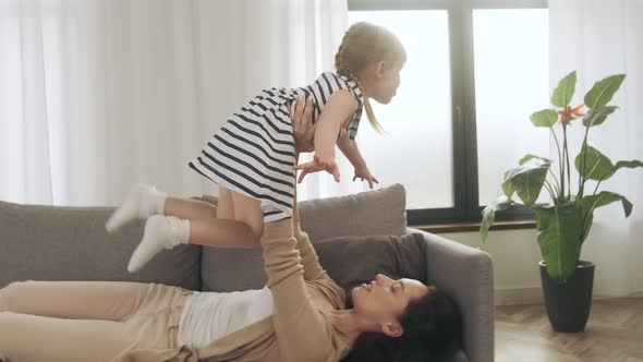 Mother and Daughter Doing Yoga at Home