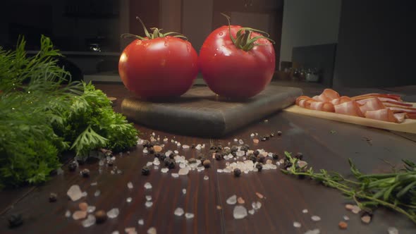 Slide Video of Two Ripe Red Tomatoes Are in the Beam of Light on the Kitchen Table, Ingredients for