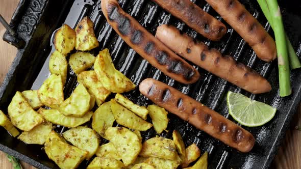 Baked Potatoes and Grilled Soy Sausages on Dark Wooden Background