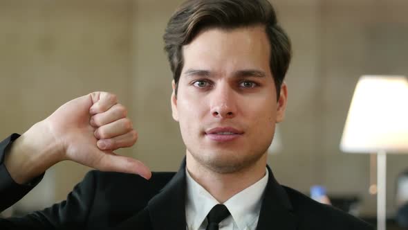 Thumbs Down by Businessman, Portrait in Office