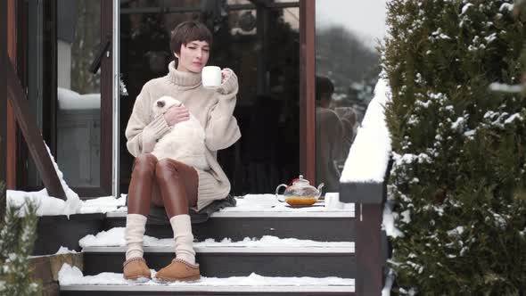 Peaceful Young Woman Drink Tea on Home Terrace in Winter