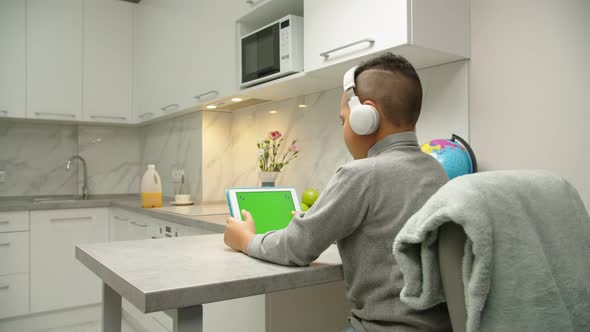 Boy Simulating Playing Game on Tablet with Chroma Key Green Screen