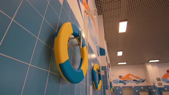Lifesavers Hang in Hallway of Pool for Junior Sportsmen
