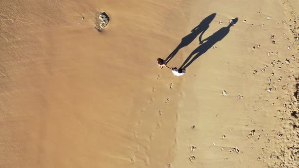 Beautiful boy and girl on romantic honeymoon enjoy life on beach on white sand 4K background