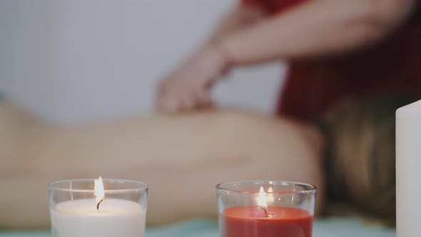 Girl Massage Therapist Works with Young Client Back in Salon