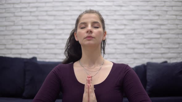Attractive Woman Meditating at Home Yoga Lotus Pose Relaxing Namaste Hands