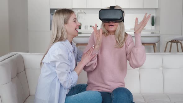 Adult Daughter Showing To Her Older Mother Using New Technology To Exploring the Virtual World