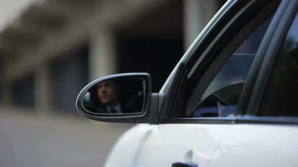 Driver Opening Car Window and Paying Hundred Dollars for International Highway