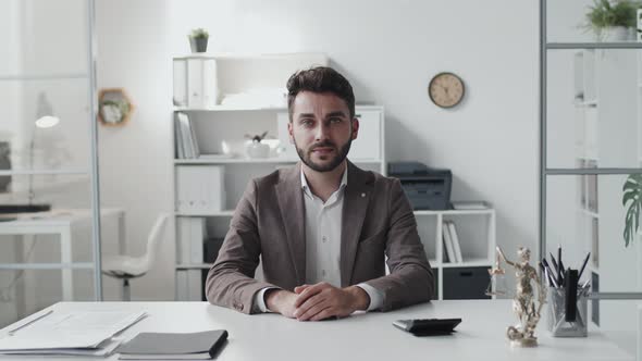 Man Sitting at Desk in Office