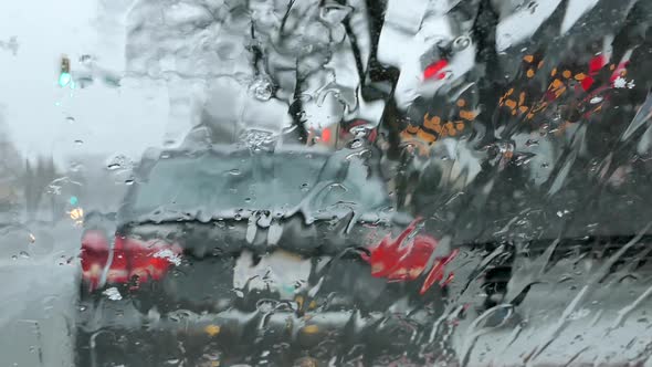 Snowstorm Street - Car Windshield - Shop and People