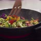 Preparing vegetables on a frying pan for healthy vegan dinner - VideoHive Item for Sale
