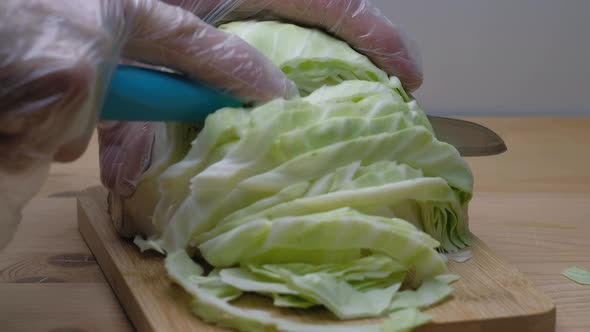 A Chef In Gloves Cuts A Fresh  With A Knife.