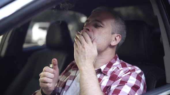 Man Lightning Cigarette and Smoking Sitting in Car on Driver's Seat