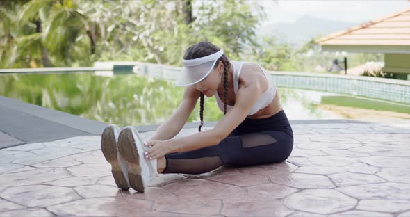 Slim Woman Exercising on Poolside