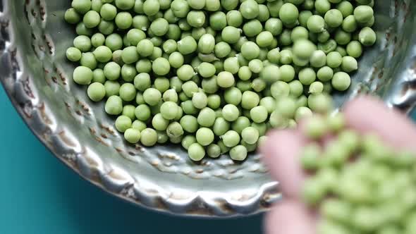 Slow Motion of Dropping Fresh Organic Peas in a Bowl 