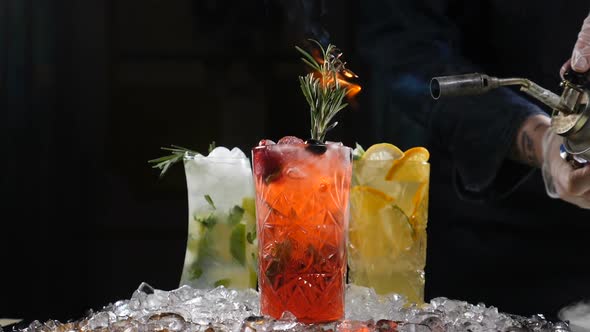 Serving Fresh Coctails with Culinary Torch. Burning Rosemary. Slow Motion. Roasting of Rosemary for