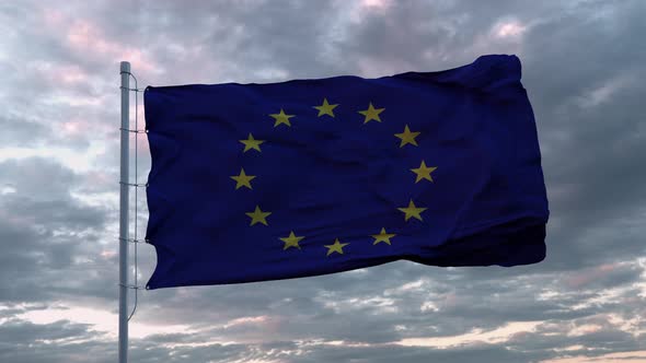 Waving European Union Flag in the Wind at Sunset Sky