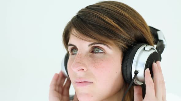 Teenage girl wearing headphones and listening to music