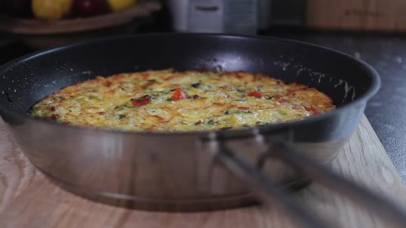 Slow Pan right to left of cooked golden brown tomato, red pepper, kale, zucchini/ courgette, bacon a