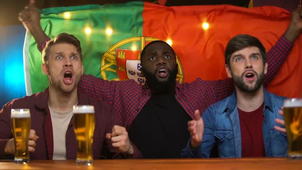 Anxious Multiracial Football Fans With Portuguese Flag Unhappy Team Losing Match