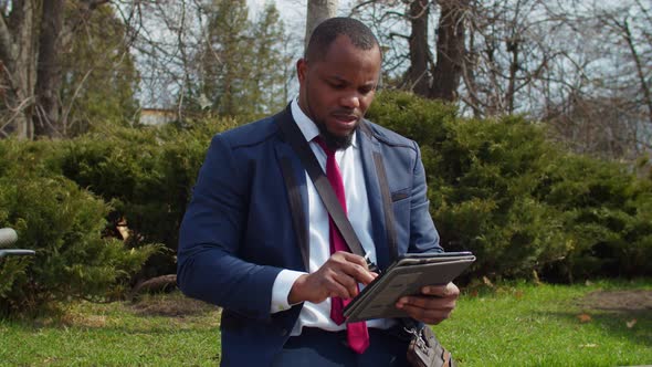 African White Collar Worker Relaxing in Park During Break at Work