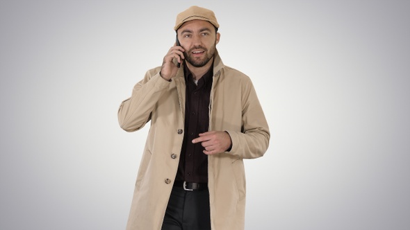 Young fashionable businessman talking on mobile phone on