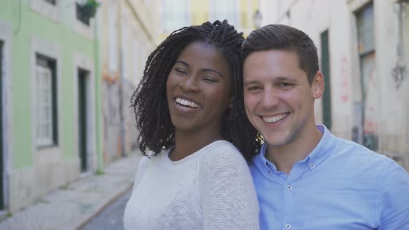 Happy Multiracial Couple Looking at Camera