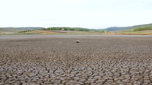 A Huge Area of a Very Dry Lake Suffering From Drought, Next To It Everything Is Green