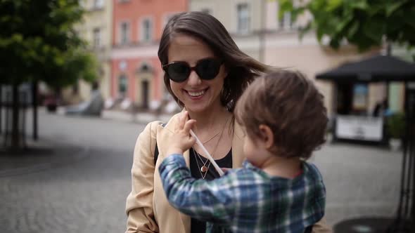 Mother with a toddler boy in old city center.