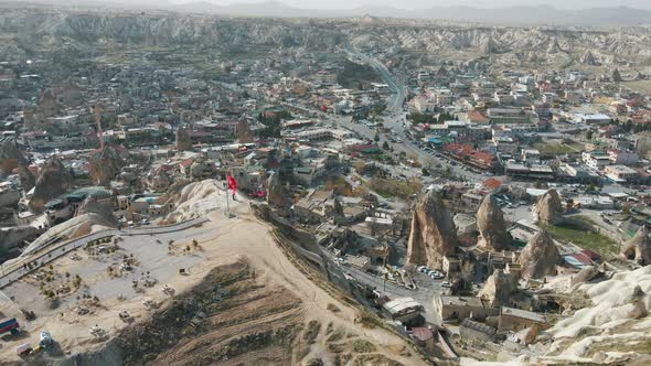 Aerial top drone shot over the town at the foothills in Cappadocia, Turkey at daytime.