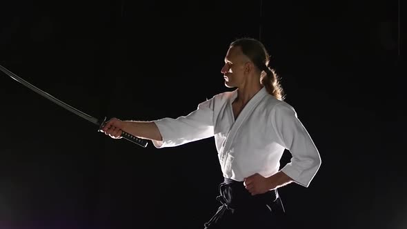 Man Fighting at Aikido Training with Japanese Sword Katana in Martial Arts School. Healthy Lifestyle