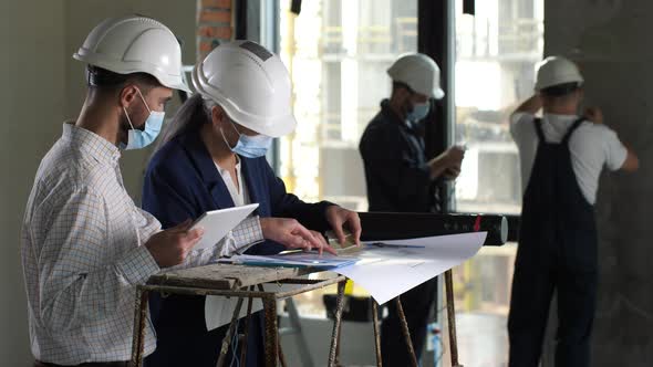 Masked Designers Choosing Colors for Flat Interior