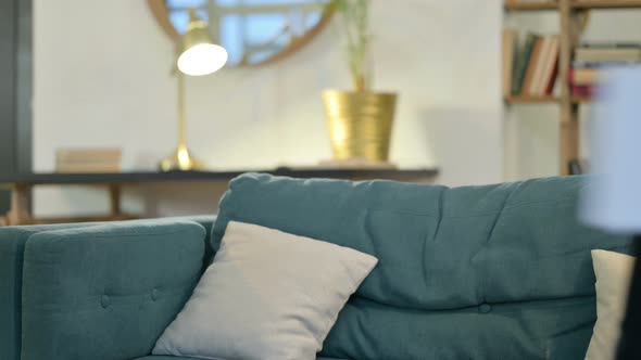 Young African Man with Laptop Coming Back, Sitting on Sofa 