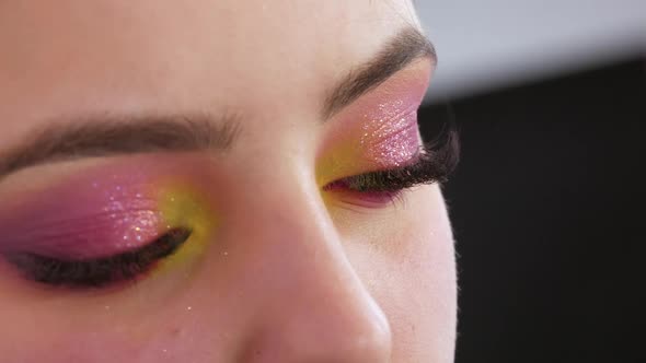 Professional Makeup Artist Makes Bright Fashion Makeup to Model in Yellow and Pink Eyeshadows on the