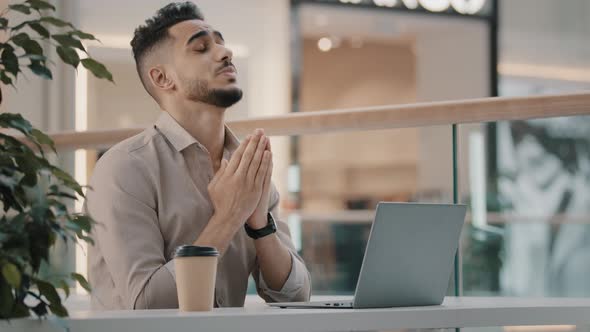 Arabian Ethnic Businessman Male Worker User Guy Sits at Table in Cafe Office with Laptop Hopes Pray