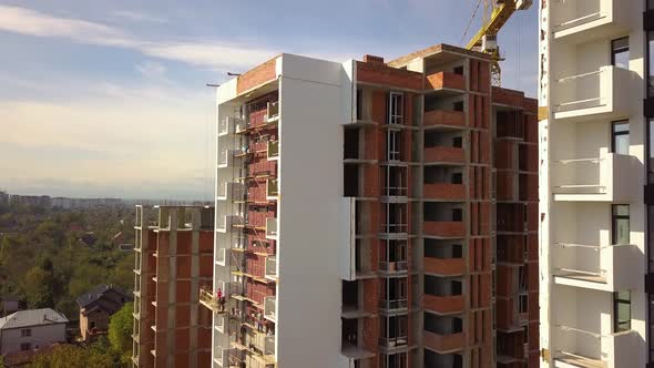 Aerial view of high residential apartment building under construction. Real estate development