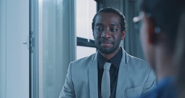 African businessman smiling and shaking hand with recruiters