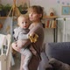 Mom Standing with Baby Son in Kids Room - VideoHive Item for Sale