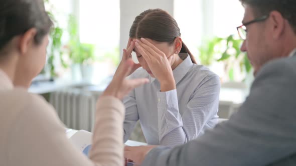 Angry Male and Female Colleagues Scolding Latin Female Colleague