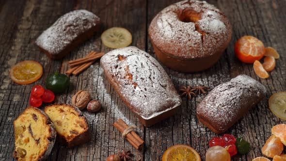 Christmas Composition of Dried Fruits and Stollen with Tangerine on a Wooden Textured Table with