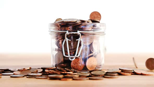 Close-up of coins falling in bottle